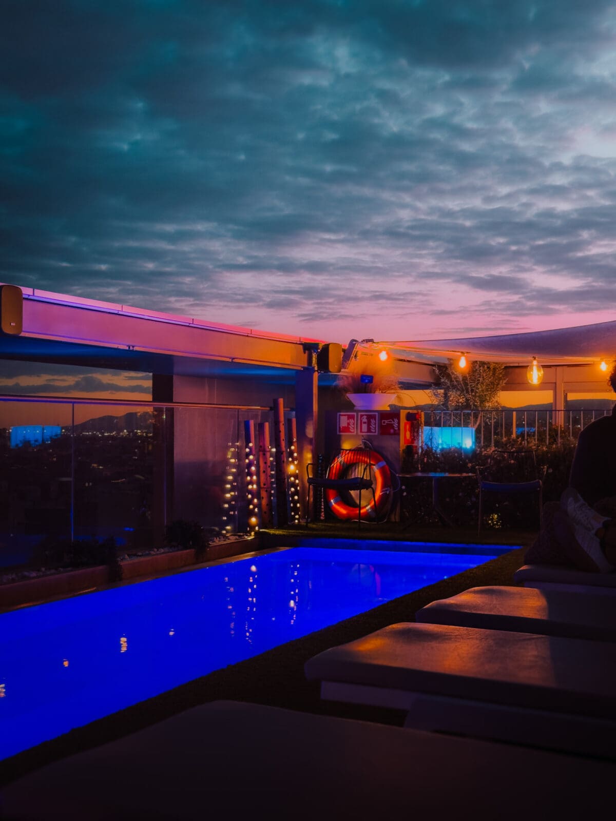 Beleuchteter Rooftop-Pool des Occidental Barcelona 1929 am Abend