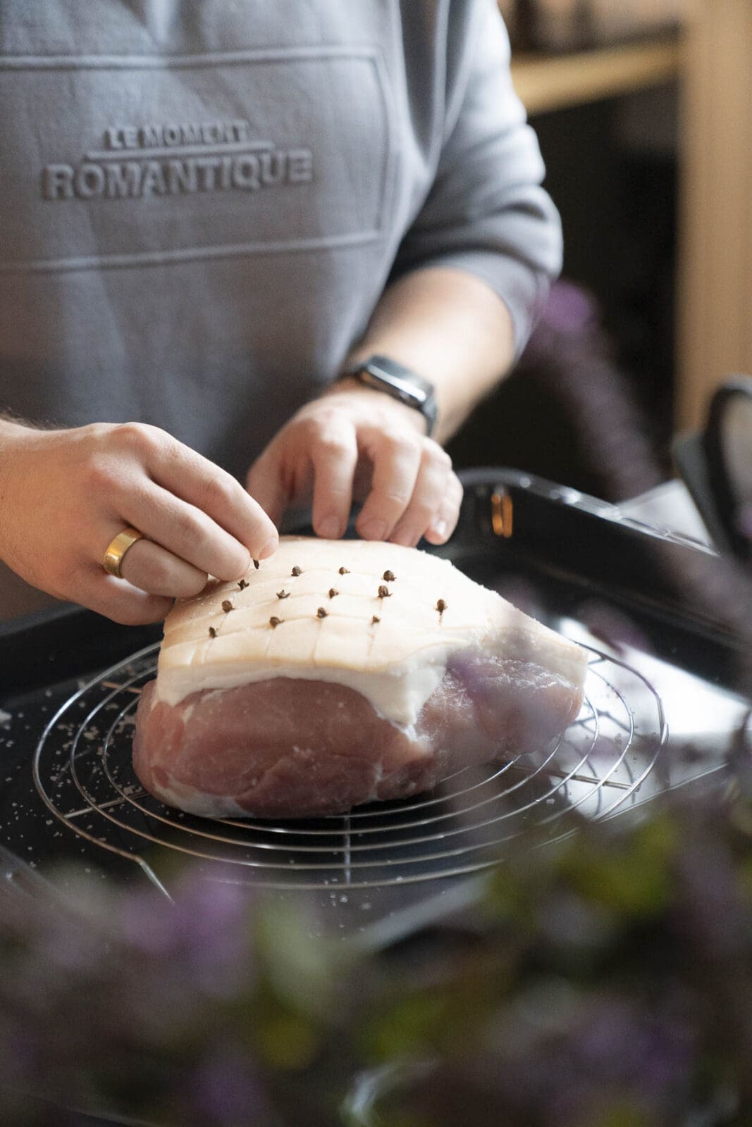 Krustenbraten mit Orangen-Whisky-Glasur 4 Fleisch wird mit Nelken für das Braten vorbereitet.